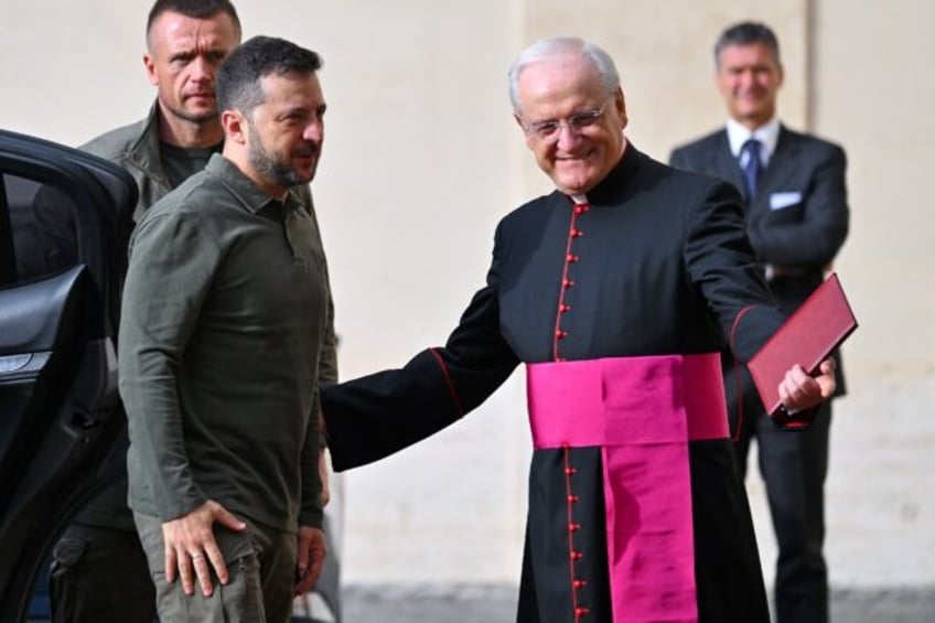 Ukraine's President Volodymyr Zelensky (L) is welcomed by Prefect of the Pontifical House,