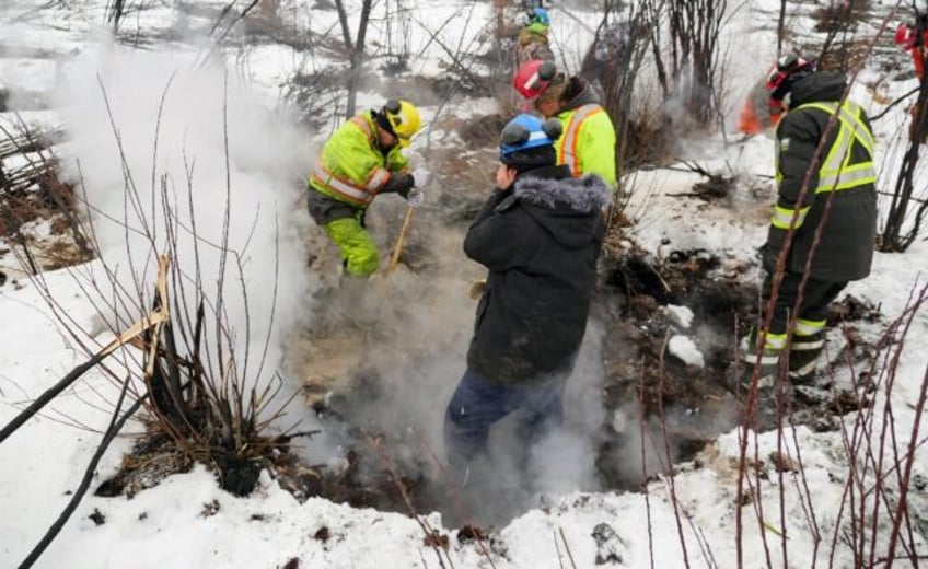 This handout picture provided by Alberta Wildfire shows authorities battling a blaze in Fo